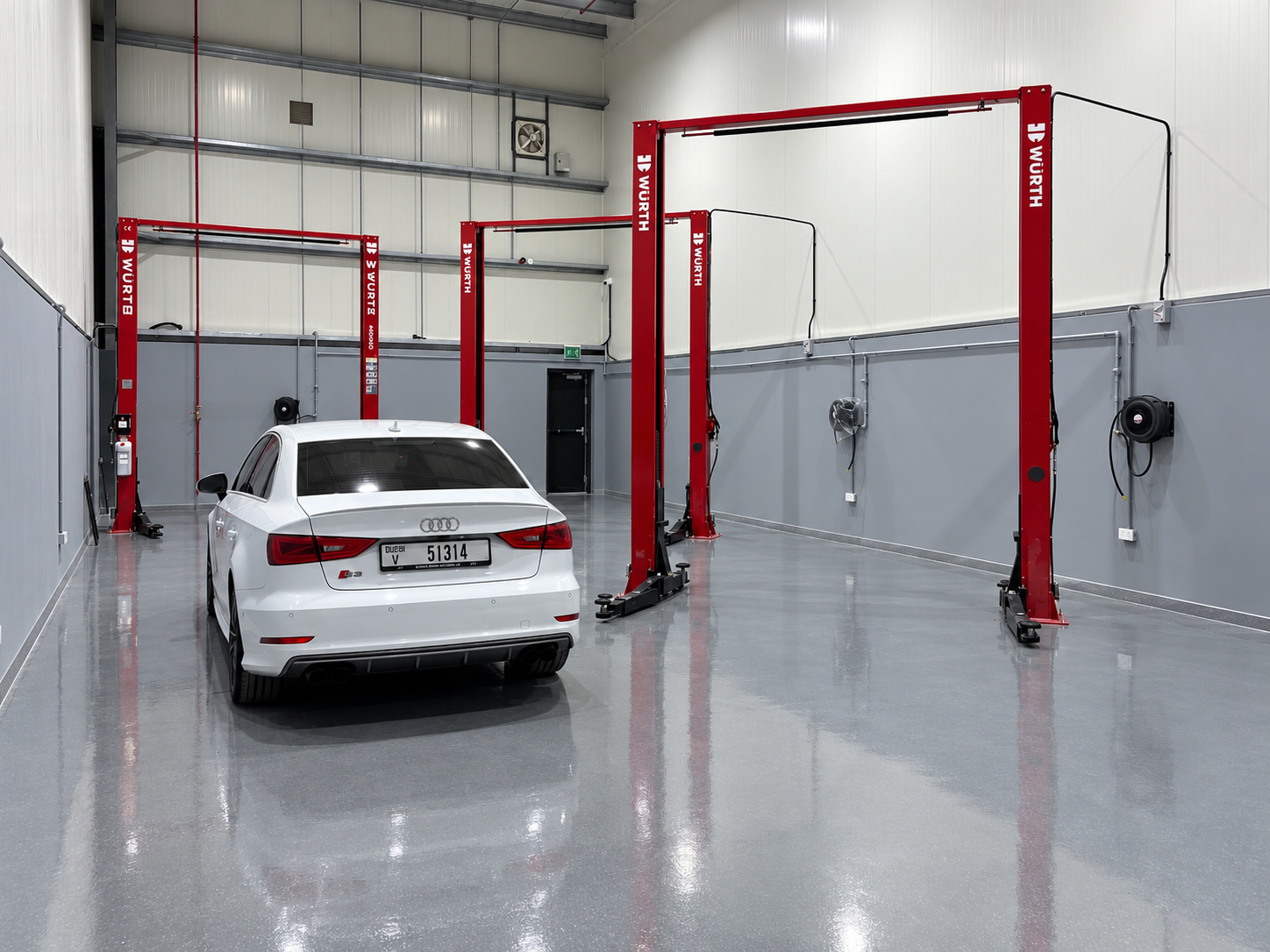 Rear view of a white Audi S3 in the clean Wolfsburg Motor Service workshop